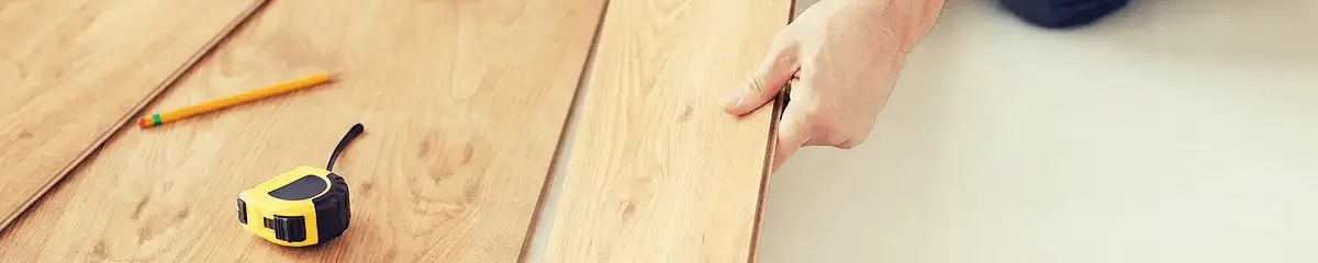 A professional installing wood flooring in Orlando, FL